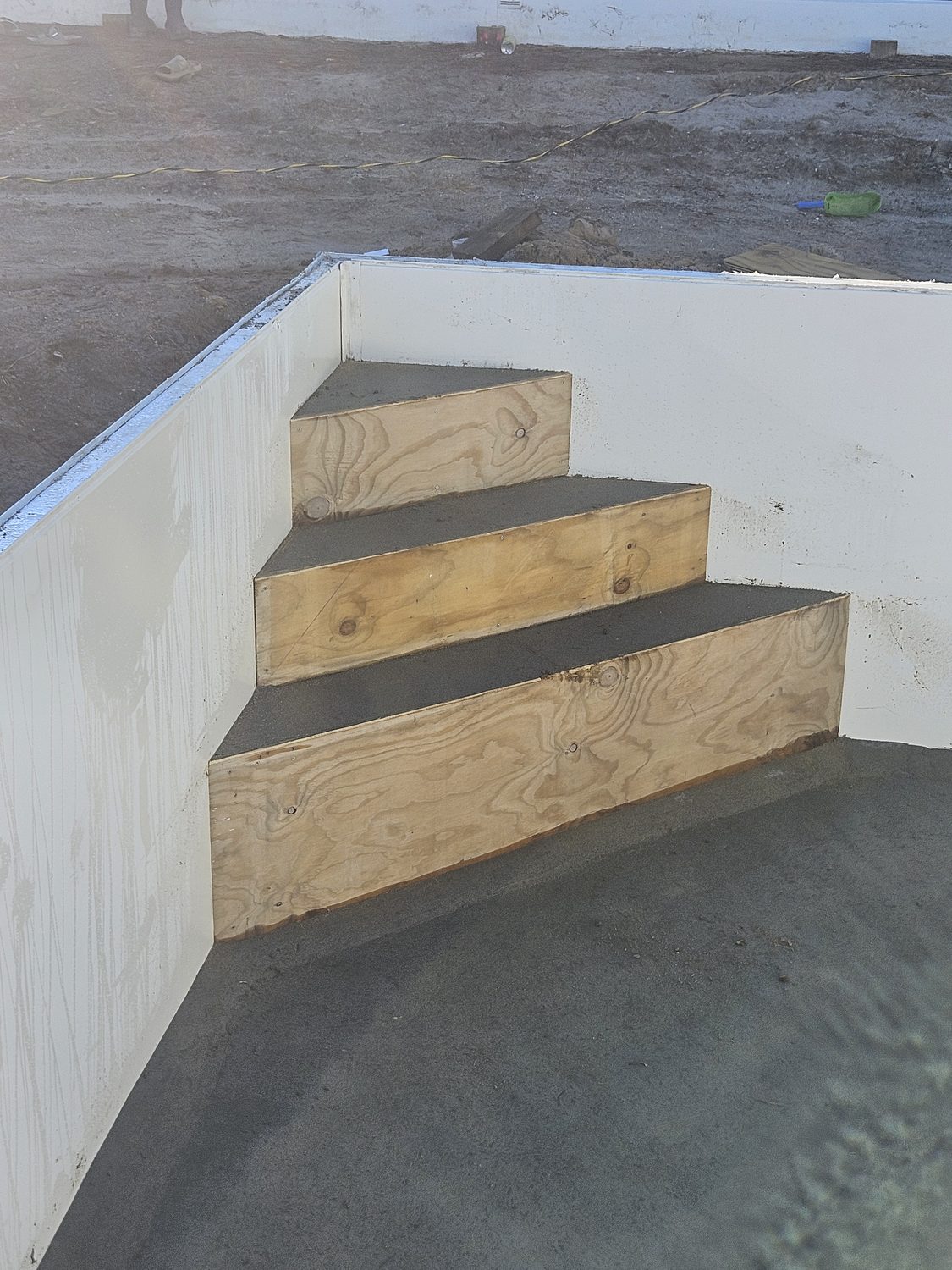 Plywood formwork for pool steps inside a new pool wall