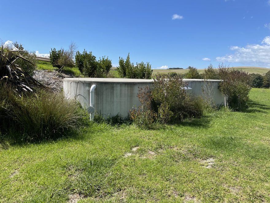 Concrete water tanks with shrubs around them